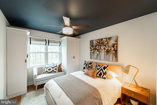 bedroom with wood finished floors and a ceiling fan