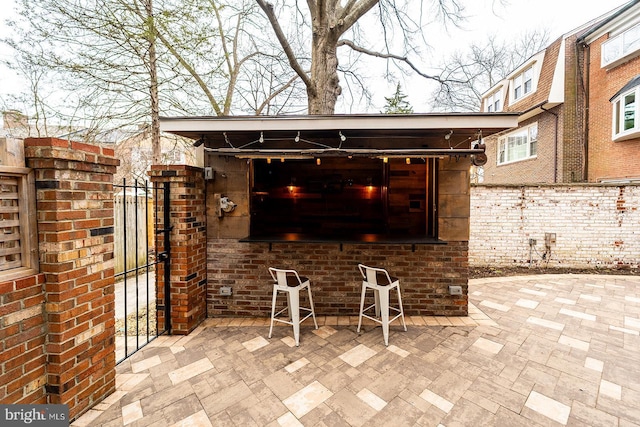 view of patio / terrace featuring fence and a gate