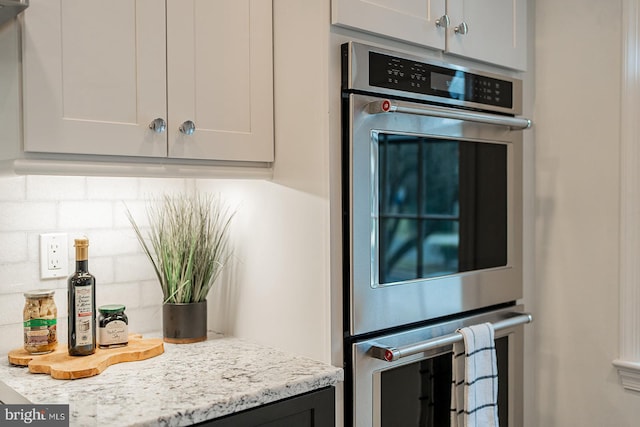 kitchen with double oven and light stone countertops