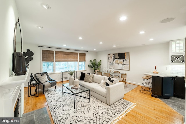 living room featuring recessed lighting, wood finished floors, and baseboards