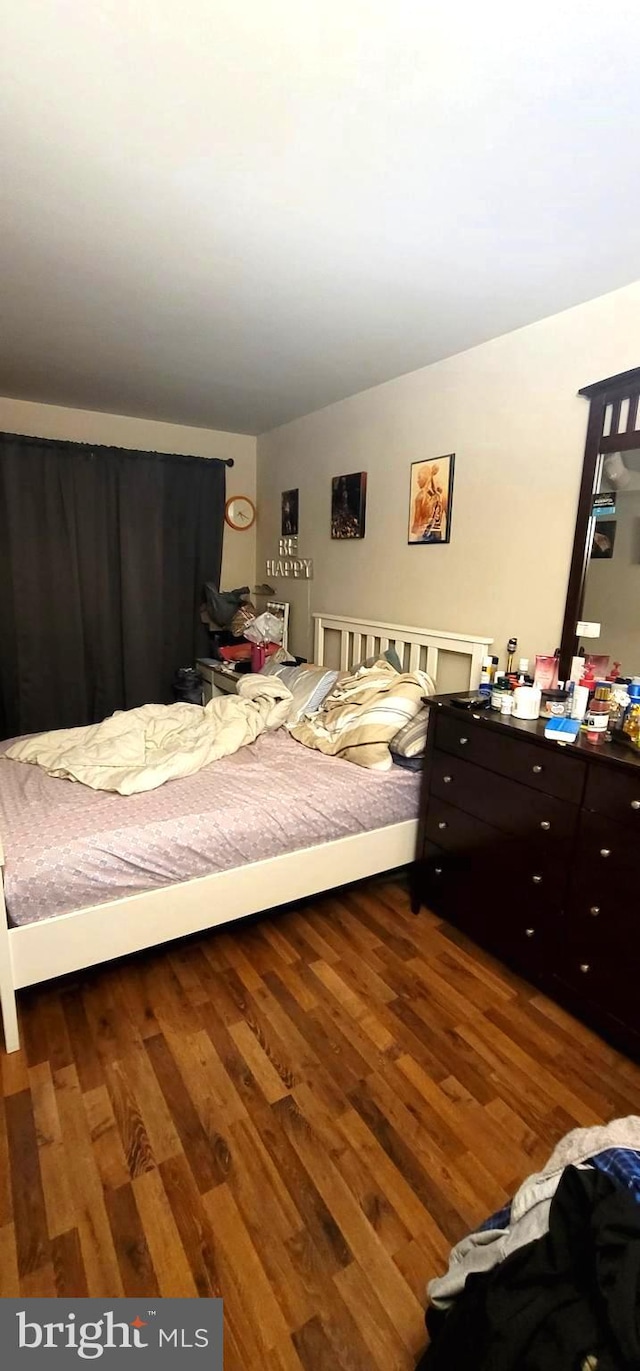 bedroom with wood finished floors