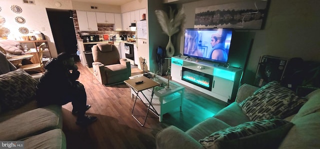 living room featuring visible vents and wood finished floors