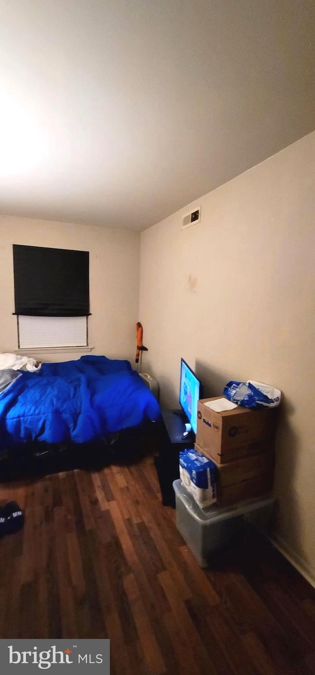 bedroom with visible vents and wood finished floors