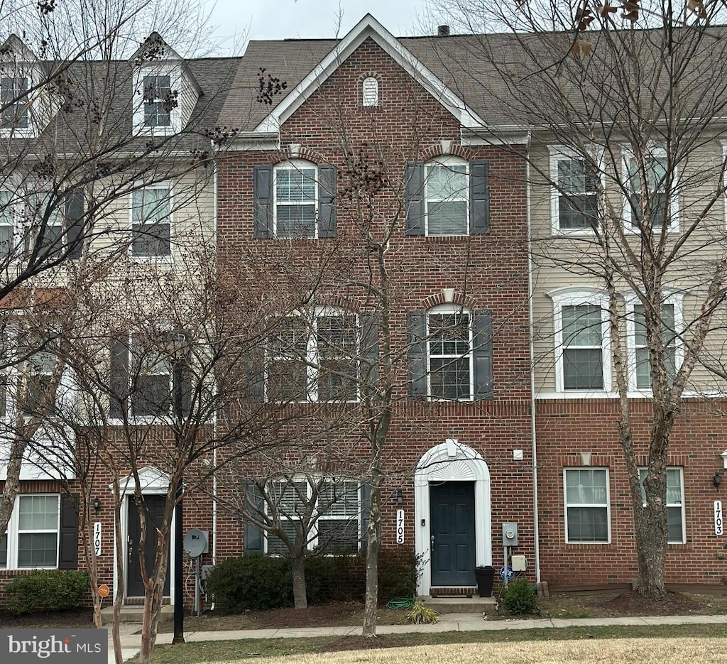 view of property featuring brick siding