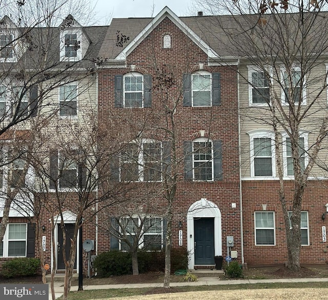 view of property featuring brick siding