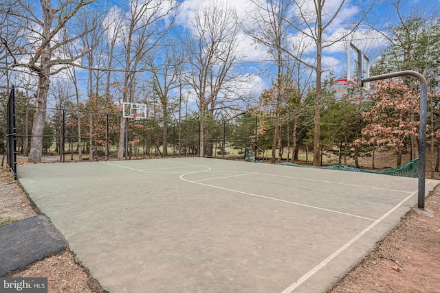 view of basketball court with community basketball court and fence