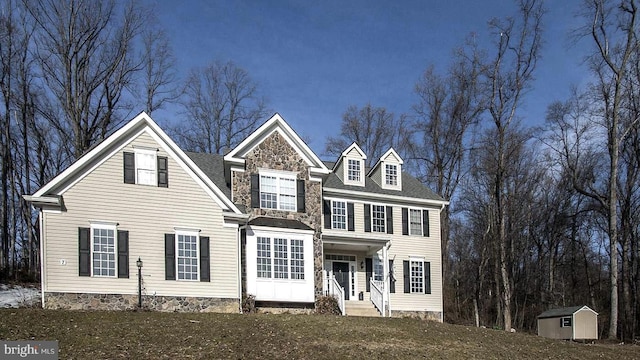 view of front of house featuring an outdoor structure and a storage unit