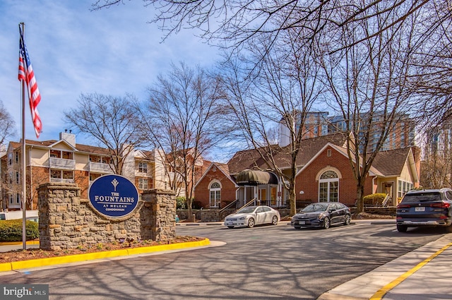 view of road featuring a residential view and curbs