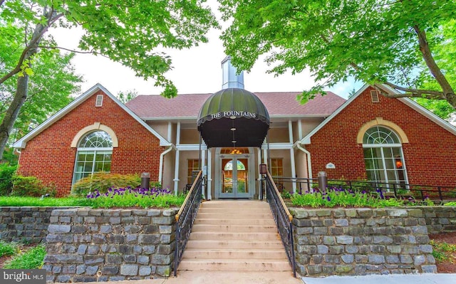 view of front of house featuring french doors and brick siding