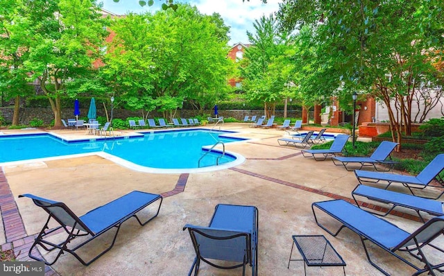 pool featuring a patio and fence