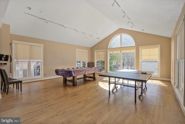 game room featuring track lighting, baseboards, light wood-style flooring, a textured ceiling, and billiards