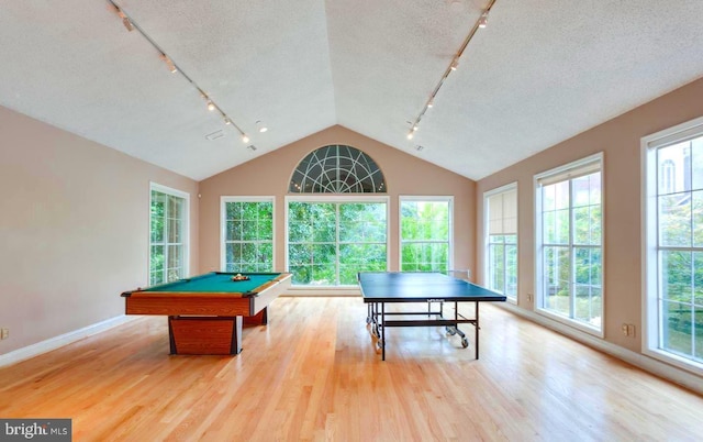 game room with pool table, a textured ceiling, lofted ceiling, and wood finished floors