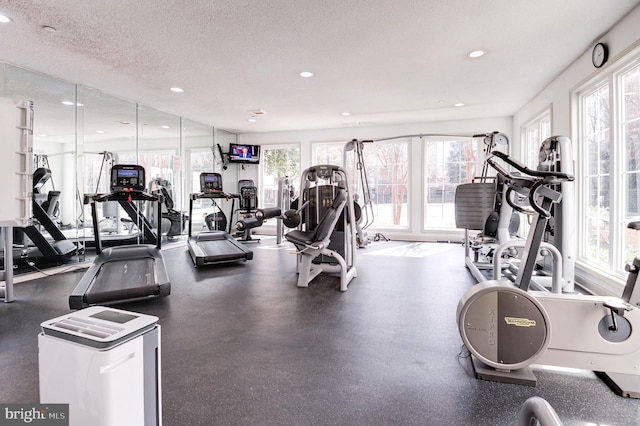 gym with recessed lighting and a textured ceiling