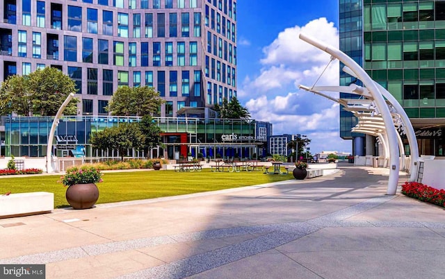 view of home's community featuring a lawn and a view of city