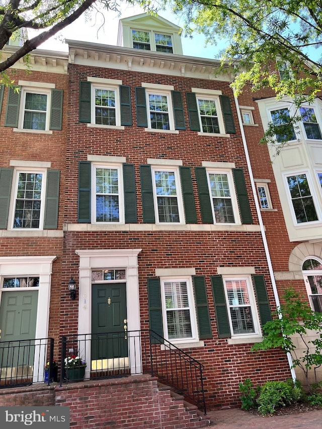 townhome / multi-family property featuring brick siding
