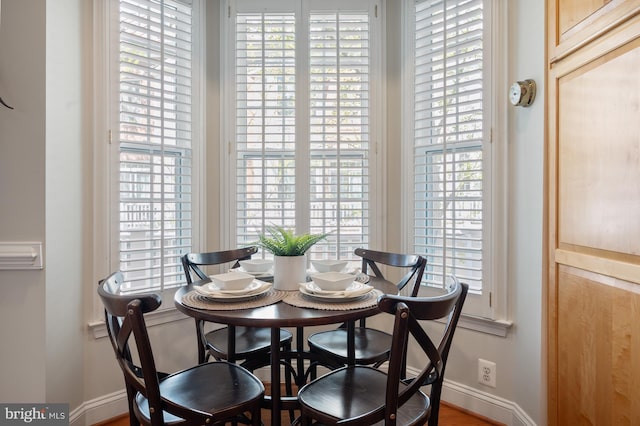 dining space with baseboards and a healthy amount of sunlight