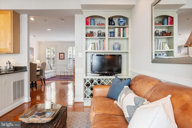 living room with visible vents and wood finished floors