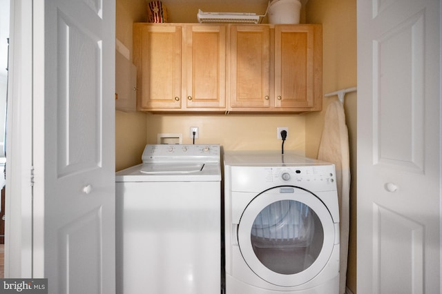 laundry room with washer and dryer and cabinet space