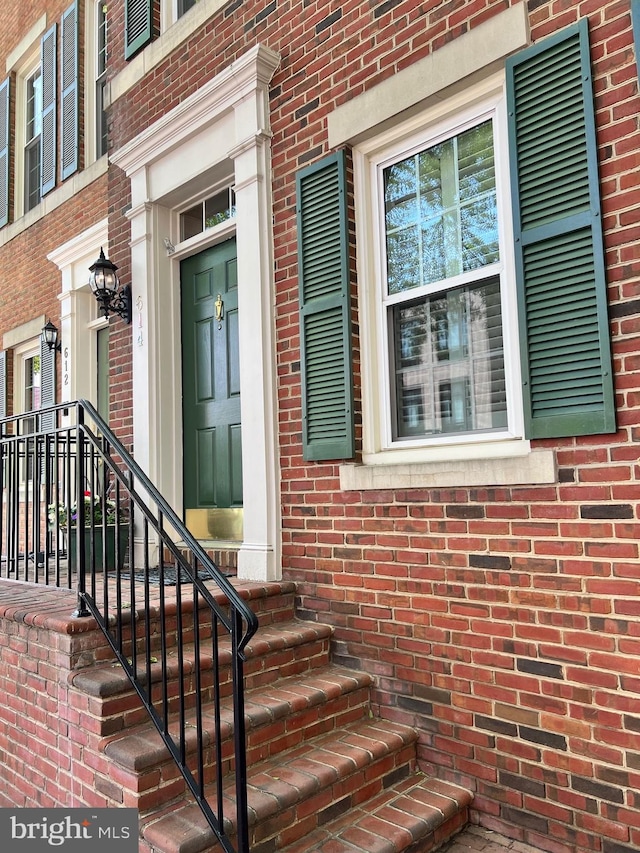 property entrance with brick siding