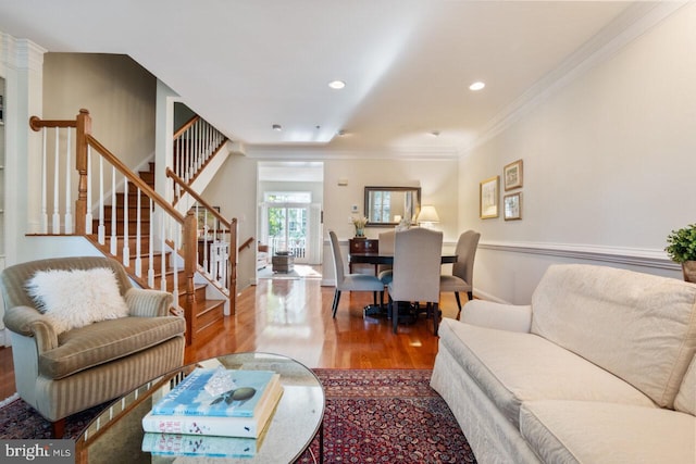 living room featuring stairs, recessed lighting, crown molding, and wood finished floors