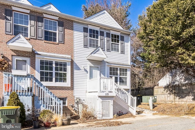 multi unit property featuring brick siding and fence