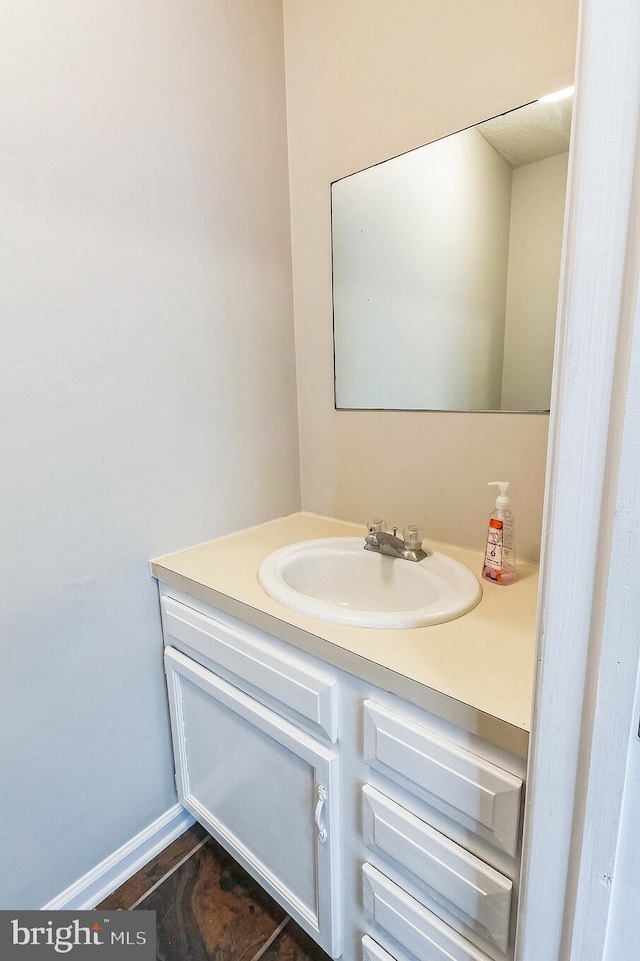 bathroom with vanity and baseboards