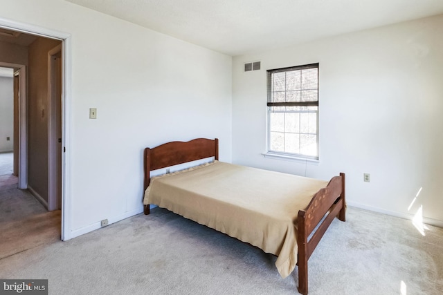 bedroom with visible vents, baseboards, and carpet flooring