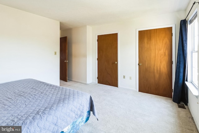 carpeted bedroom with baseboards