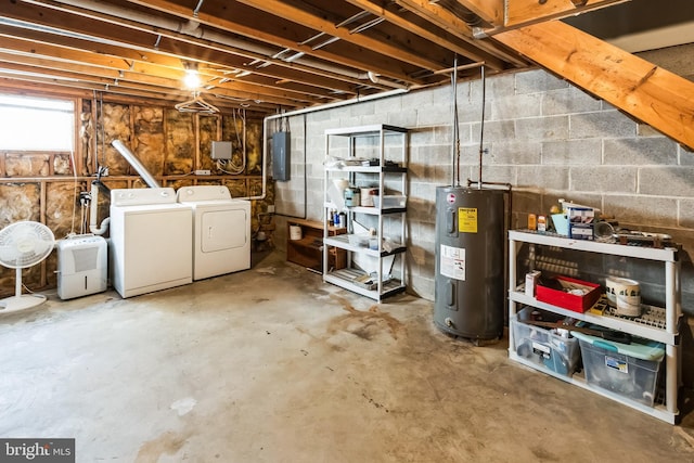 below grade area with electric water heater and washing machine and dryer