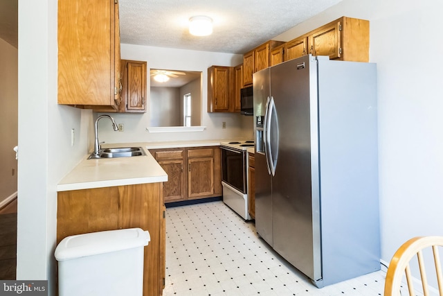 kitchen featuring black microwave, white range with electric cooktop, light floors, stainless steel refrigerator with ice dispenser, and a sink