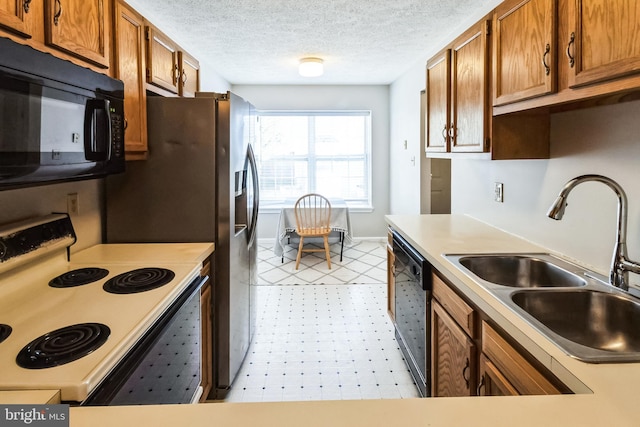 kitchen with brown cabinets, electric stove, a sink, black microwave, and dishwasher