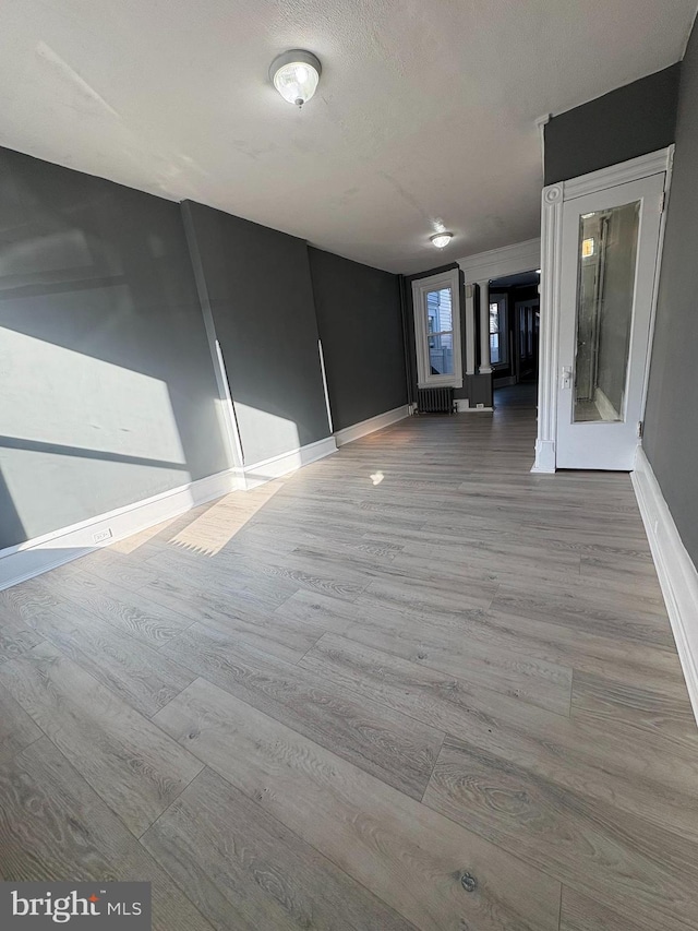 spare room with wood finished floors and baseboards