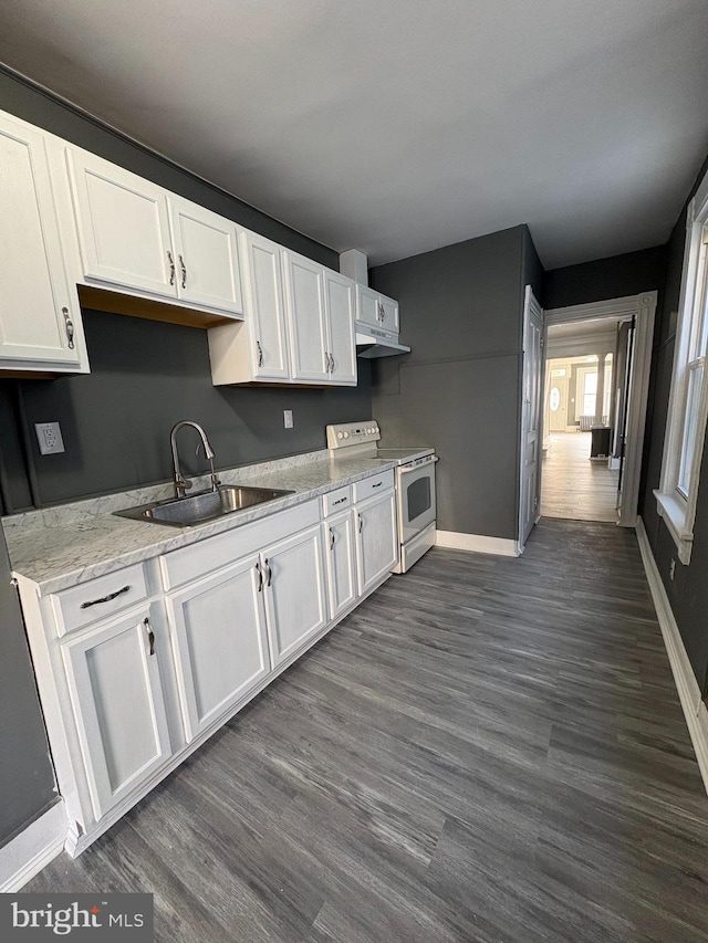 kitchen with electric range, a sink, under cabinet range hood, dark wood finished floors, and white cabinets