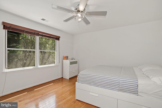 bedroom featuring visible vents, light wood-style flooring, and ceiling fan