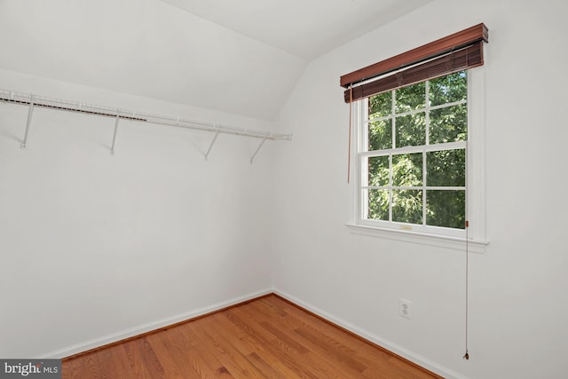 spacious closet featuring lofted ceiling and light wood-style floors