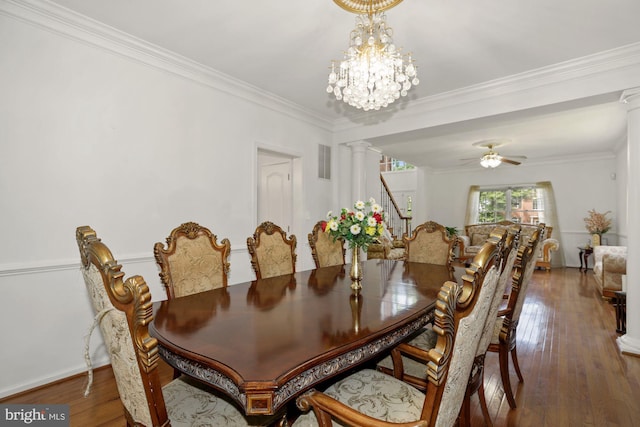 dining room featuring decorative columns, ceiling fan with notable chandelier, ornamental molding, and hardwood / wood-style flooring