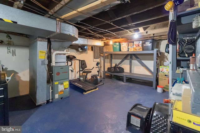 unfinished basement featuring heating unit