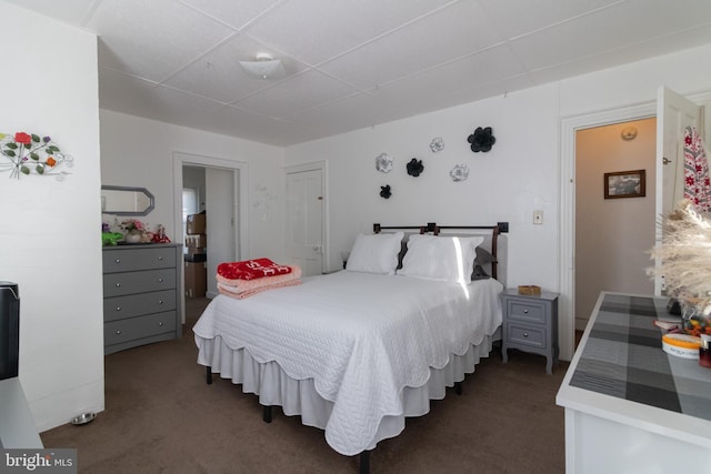 bedroom featuring dark colored carpet