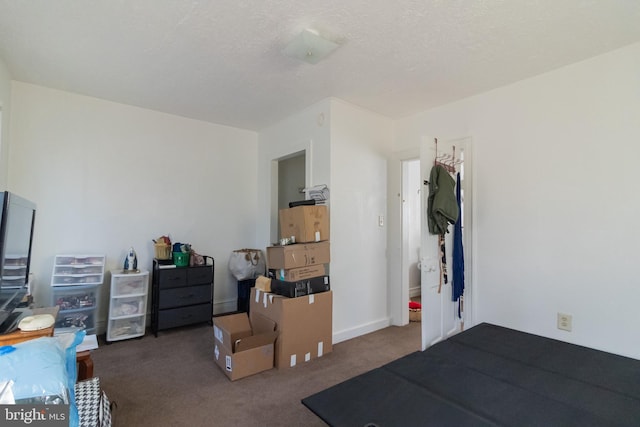 carpeted bedroom featuring a textured ceiling