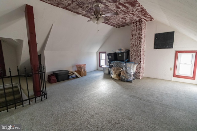 bonus room featuring lofted ceiling, carpet, and ceiling fan