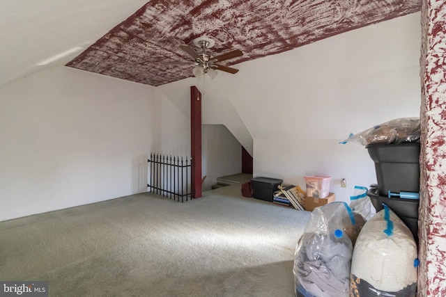 additional living space featuring carpet, ceiling fan, and vaulted ceiling