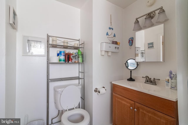 bathroom featuring toilet and vanity