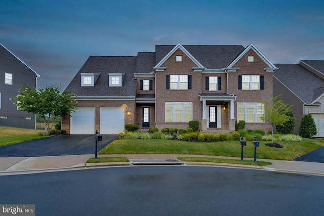 view of front of home with brick siding, a front lawn, roof with shingles, a garage, and driveway