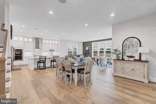 dining area with light wood finished floors, recessed lighting, and a wealth of natural light