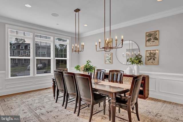 dining room with crown molding, a decorative wall, recessed lighting, and light wood finished floors