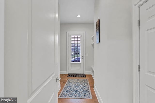 doorway featuring visible vents, recessed lighting, wood finished floors, and baseboards