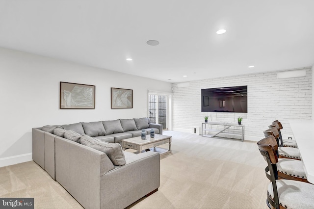 living room with recessed lighting, carpet, baseboards, and brick wall