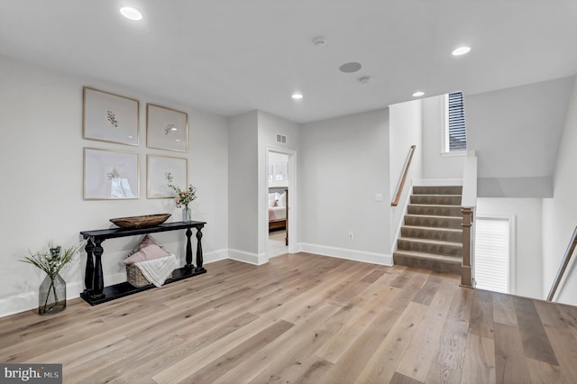 interior space with recessed lighting, stairway, light wood-style flooring, and visible vents