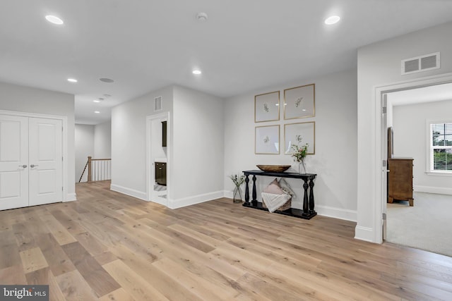 interior space featuring recessed lighting, visible vents, baseboards, and light wood-style floors