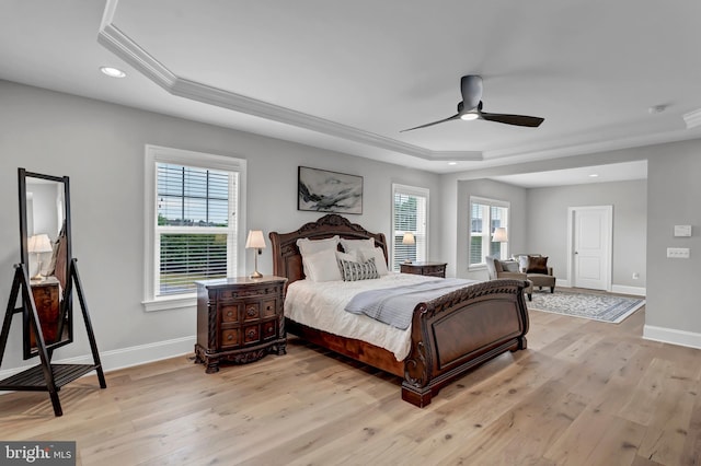 bedroom featuring recessed lighting, baseboards, a raised ceiling, and light wood-style floors